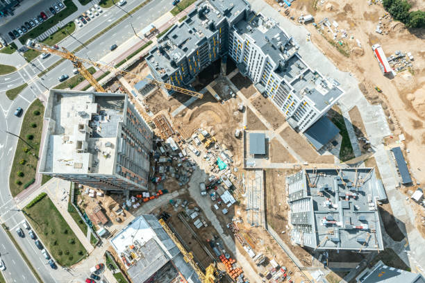 istock new residential district under construction. construction site with yellow tower cranes and machinery. aerial top view. 1424788642