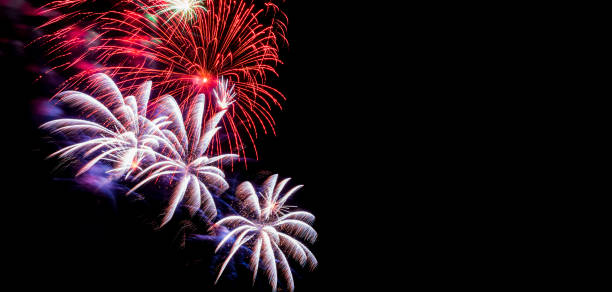 istock Festive fireworks. Bright rays from explosion of pyrotechnics, New Year's fireworks against black night sky. 1424789469