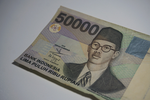 Selective focus of Indonesian rupiah currency notes in fifty thousand denomination isolated against white background