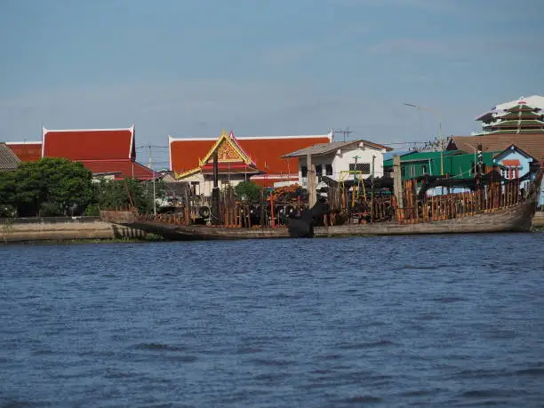 Silver-grey river canals, red-orange roof buildings, turquoise silver skies and gray-white light clouds are in the background.