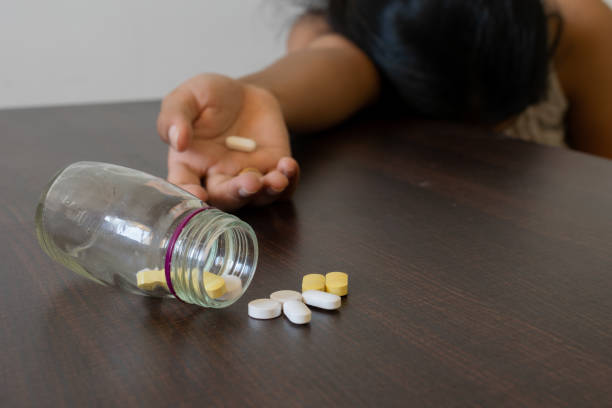 Hand of a woman, girl lying after overdose of drugs, pills, medicine due to depression, mental sickness, death, unconsciousness, fatigue, dizziness and showing attempt to suicide, murder concept. Hand of a woman, girl lying after overdose of drugs, pills, medicine due to depression, mental sickness, death, unconsciousness, fatigue, dizziness and showing attempt to suicide, murder concept. sleeping pill stock pictures, royalty-free photos & images