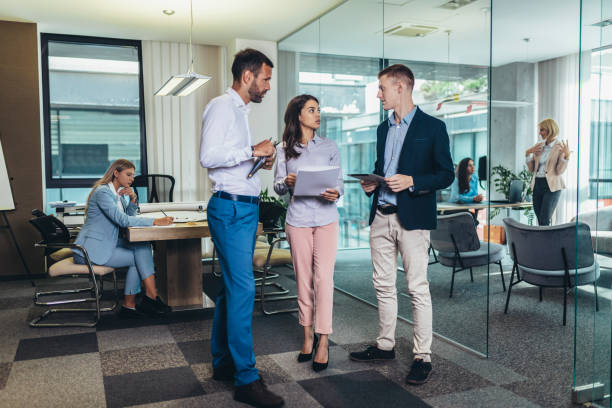 istock Group of young business people working together  while standing in creative office 1424809809
