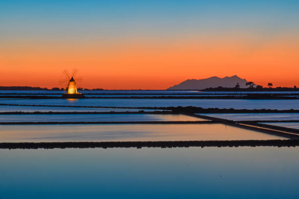 Saline di Marsala Salt pans of the Lagoon of the Stagnone of Marsala, on the distance the island of favignana egadi islands photos stock pictures, royalty-free photos & images