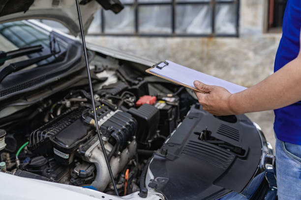 istock A young man checks his car for repairs before leaving. 1424812941