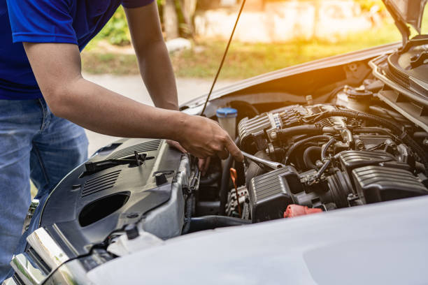 istock A young man checks his car for repairs before leaving. 1424813070
