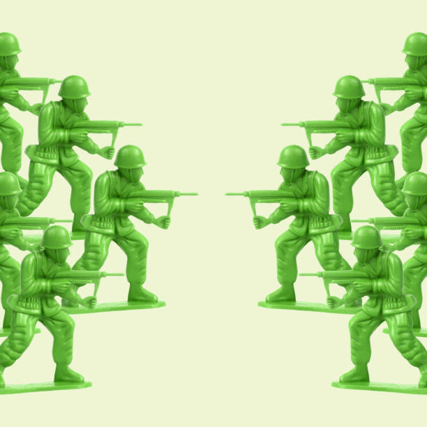 Abstract photo of war with plastic soldiers. Vintage toys as symbol of conflict. Combat concept idea battle troops Here are plastic toy soldiers as symbol of war. toy soldier stock pictures, royalty-free photos & images