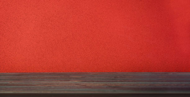 istock Empty wood table with cement red vivid wall background.Mockup product display for advertise 1424813539