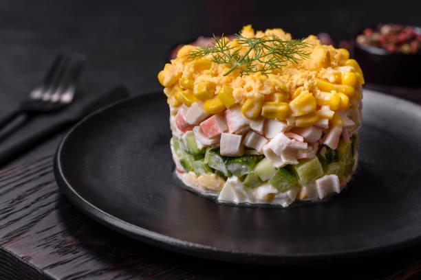 istock Fresh vegetable salad with corn, pepper, crab, cucumber, eggs and mayonnaise 1424814865