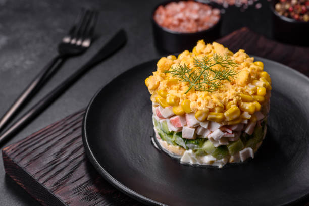 istock Fresh vegetable salad with corn, pepper, crab, cucumber, eggs and mayonnaise 1424814897