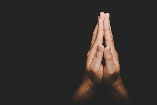 Close up Asian christian woman hands person pray and worship for thank god in church with black background, The concept for faith, spirituality and religion