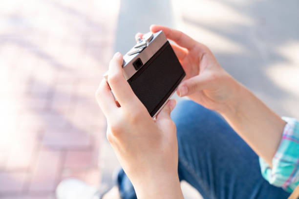 woman holding an analog camera