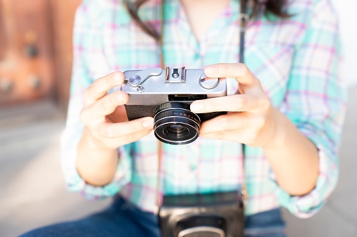 woman holding an analog camera