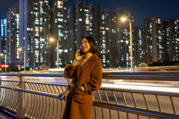 istock Asian woman making a phone call on commute 1424830628