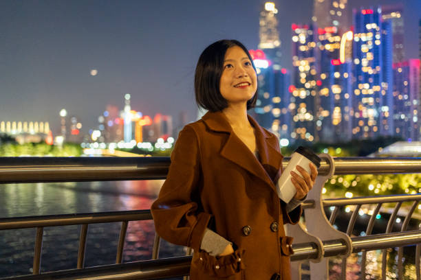 istock Asian woman walking with coffee on commute 1424831106