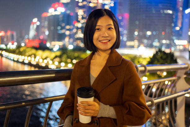 istock Asian woman looking at camera confidently on a bridge 1424831213