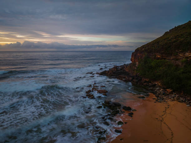 istock Cloud covered sunrise at the seaside in pink and blue 1424831250