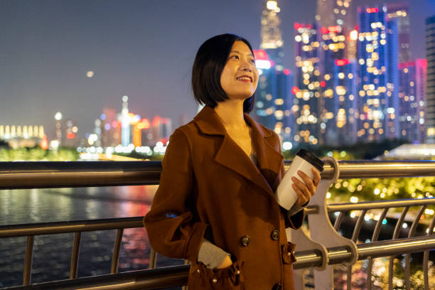 istock Asian woman walking with coffee on commute 1424831313