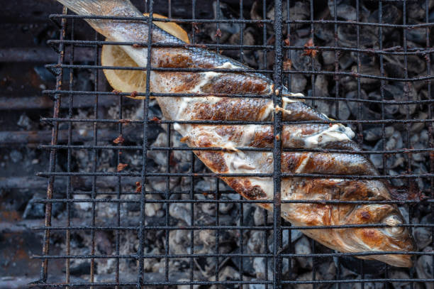 Appetizing sibas fish grilling on barbecue