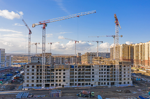 Building construction site, tall residential complex and cranes