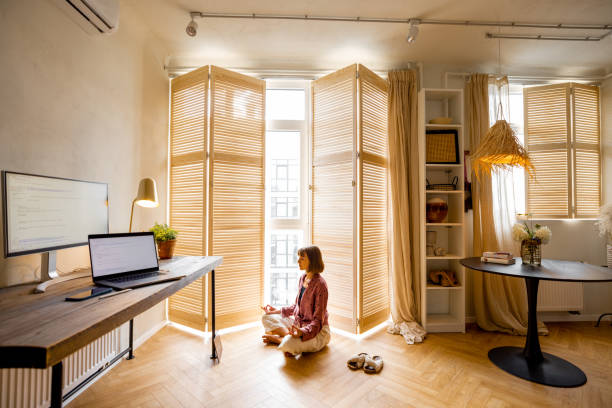 istock Woman meditates at home office 1424833514