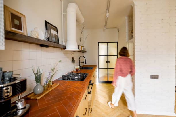 istock Modern kitchen interior with female person 1424834149