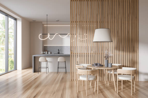 istock Stylish kitchen interior with dining area with island, kitchenware and window 1424834835