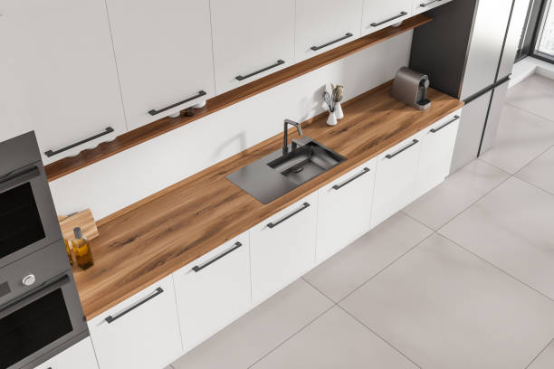 istock Top view of light kitchen interior with sink and kitchenware on deck 1424835002
