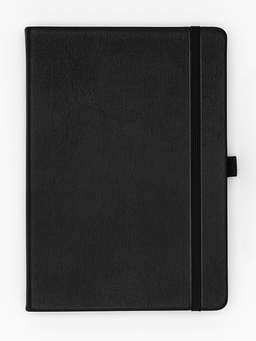 Top view, high angle of closed premium quality leather journal notebook on white background, isolated.