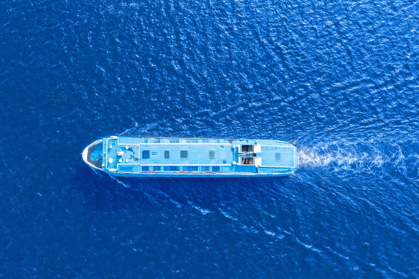 istock Small passenger ferry boat floats in sea waters, a view from a height exactly from above. 1424837974