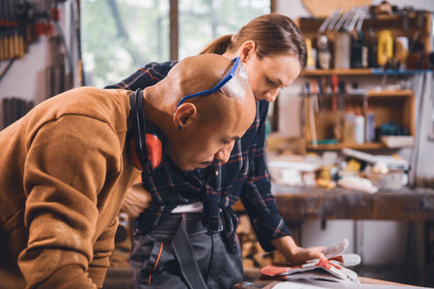 istock Couple of young carpenter working together 1424841595