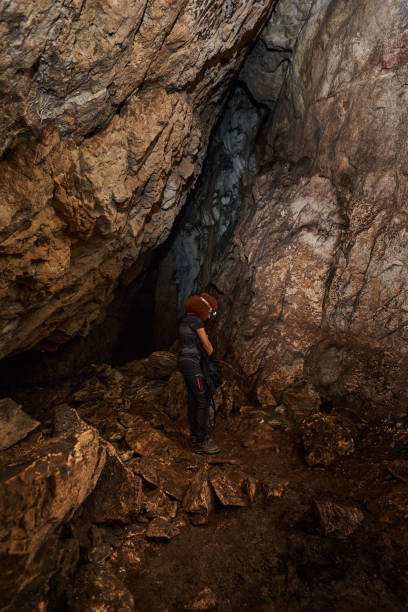 istock Woman explorer in a cave 1424846387
