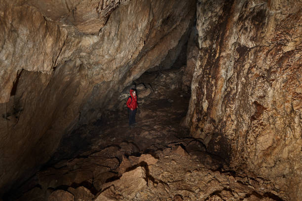 istock Woman explorer in a cave 1424846410