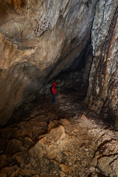 istock Woman explorer in a cave 1424846411