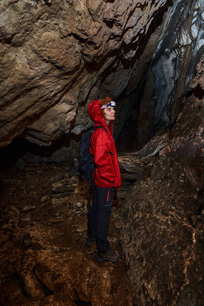 istock Woman explorer in a cave 1424846414