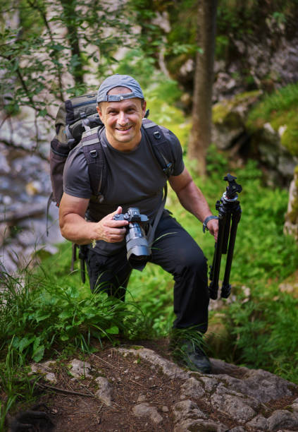 istock Nature photographer hiking in the forest 1424849097