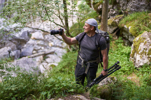 istock Nature photographer hiking in the forest 1424849099