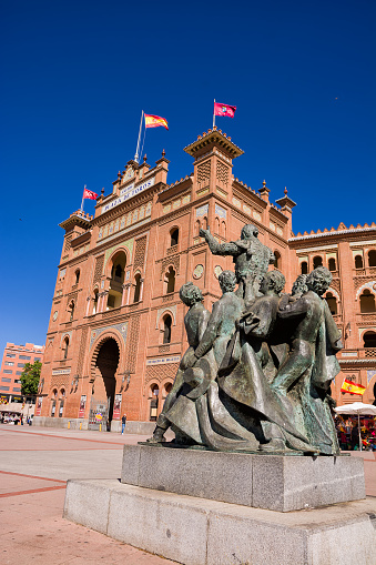 Madrid, Spain - June 19, 2022: Monument to the bullfighters in the foreground and facade and main entrance of Plaza de Toros in Madrid