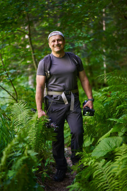 istock Nature photographer hiking in the forest 1424849165