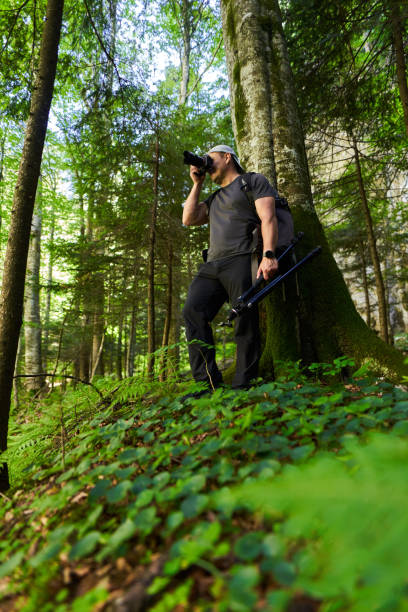 istock Nature photographer hiking in the forest 1424849740