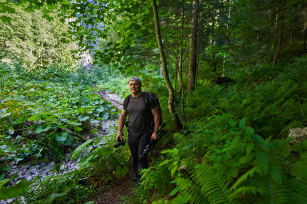 istock Nature photographer hiking in the forest 1424849746