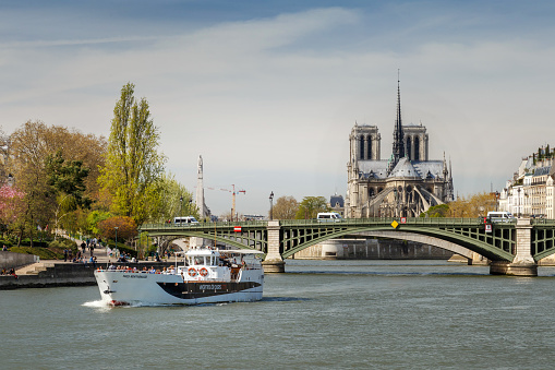 Paris, France: The Seine River leads to the Notre Dame Cathedral with a construction crane. Repairs have been going on since 2019 when a devastating fire broke out in its roof.