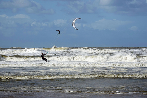 Netherlands. Scheveningen. September 17, 2022. Windsurfing on the North Sea with  stormy weather along the beach of Scheveningen