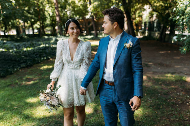 istock Bride and groom holding hands and walking together 1424856327