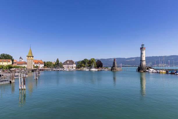 Marina of Lindau, Bodensee, Germany Marina of Lindau, Bodensee, Germany, with the lighthouse, the Bavarian Lion and the Mangturm tower in the background lindau lighthouse stock pictures, royalty-free photos & images