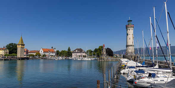 Panoramic view of the Marina of Lindau, Bodensee, Germany, with the lighthouse, the Bavarian Lion and the Mangturm tower in the background