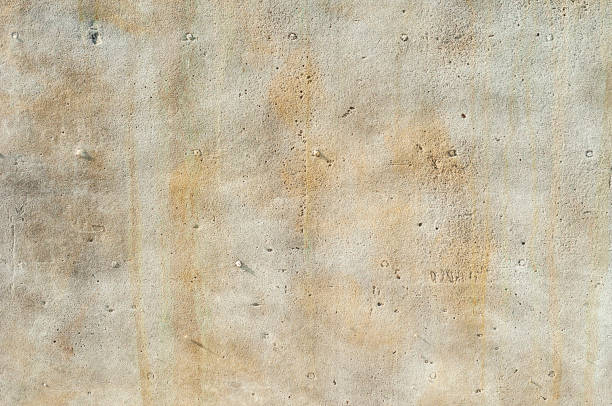 istock blurred, defocus, background, texture, cement wall or old stone with uneven gray color and yellow streaks or smudges. 1424861614