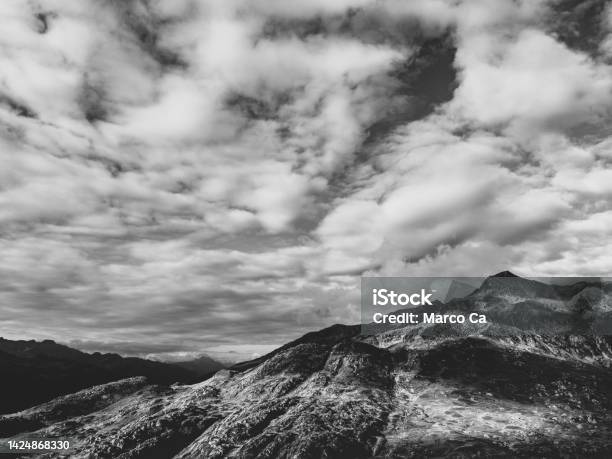 Swiss Mountain Landscape Under Partly Cloudy Sky Stock Photo - Download Image Now - Black And White, Cloud - Sky, Mountain