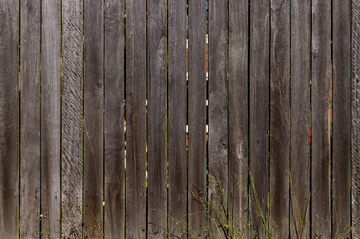 Old dark wooden fence detail.
