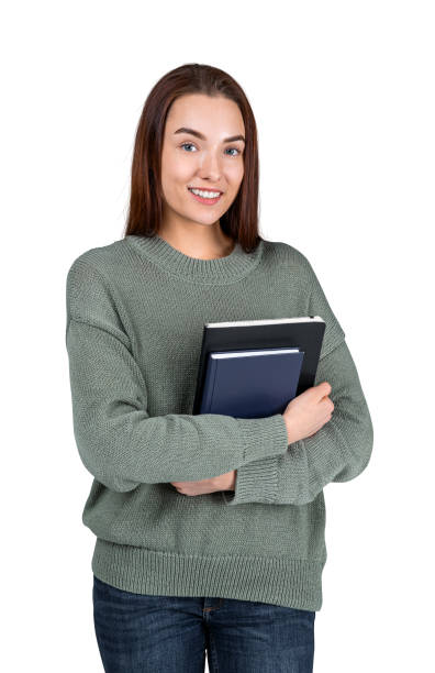 istock Young woman with notebook smiling, isolated over white background 1424871677