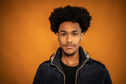 Portrait of a young man on a orange background